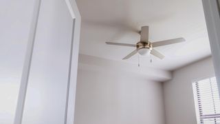 ceiling fan installed in white room on shutterstock
