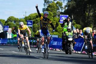 Alex Edmondson salutes as he crosses the finish line on stage 3 of the Tour of Gippsland