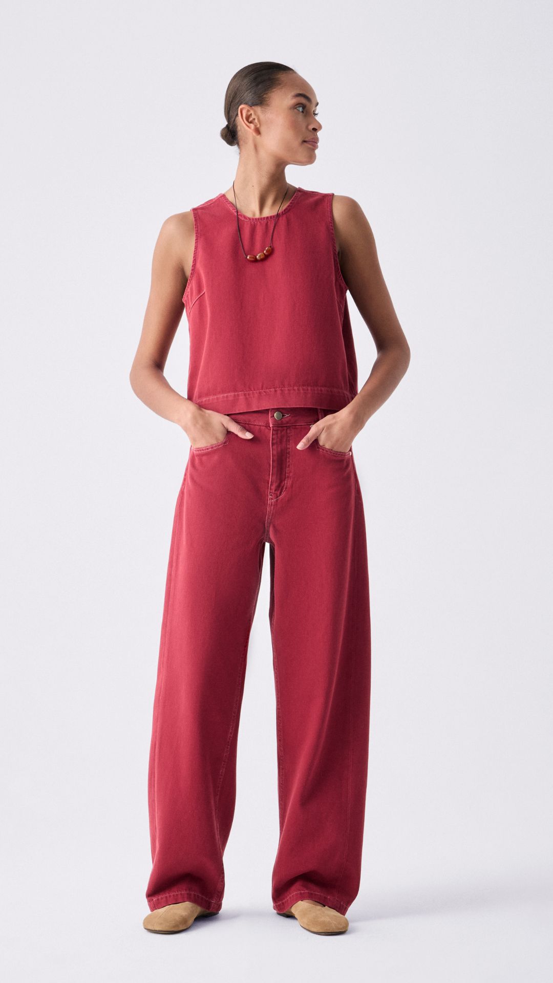 a model wearing hush denim top and red jeans