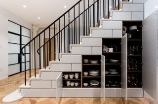 Under stairs storage idea, built in cupboards painted in Farrow & Ball Ammonite