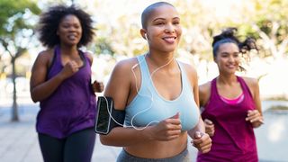 Sports bras for large breasts deals: Image of three women jogging together outside