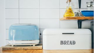 A toaster and bread bin in a kitchen