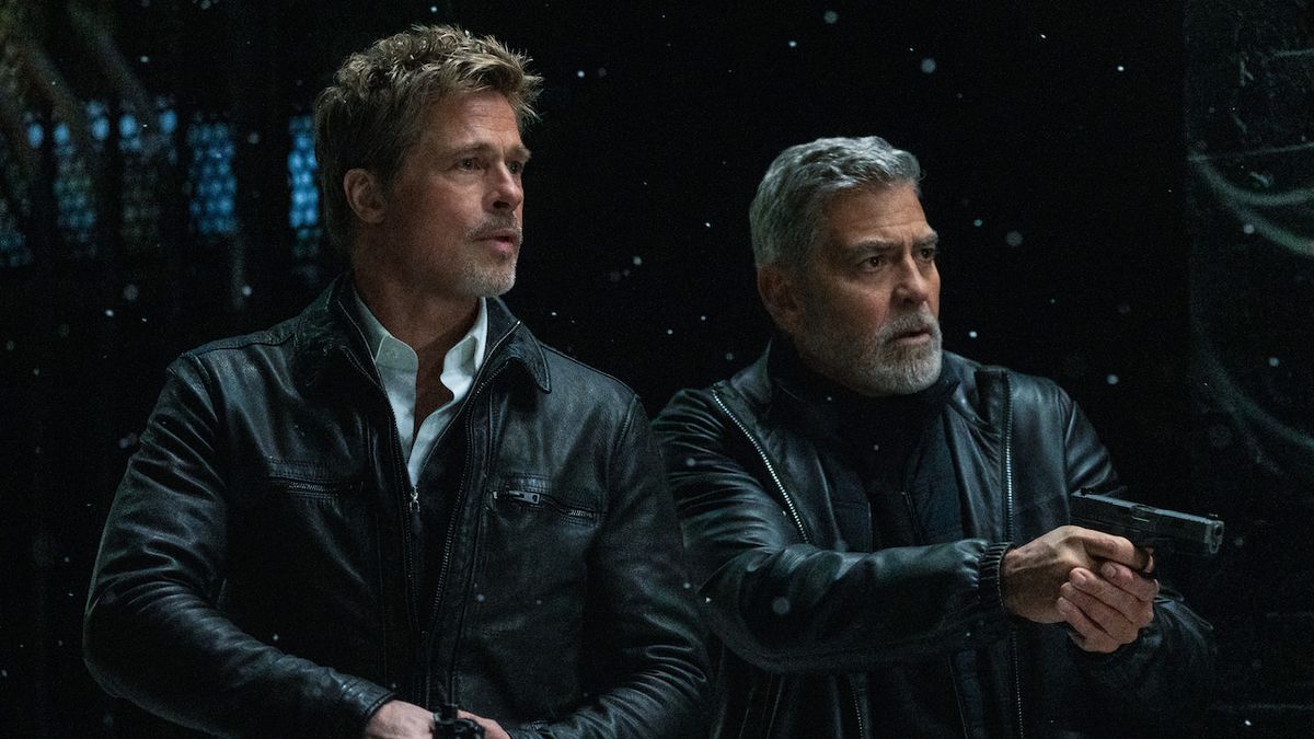 Brad Pitt and George Clooney holding guns on snowy night in Wolfs