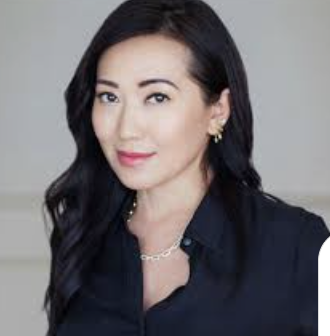 woman with black hair in a black top on a grey background
