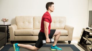 A man performing a dumbbell lunge