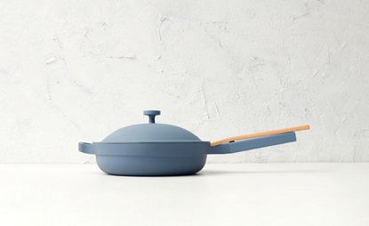 Always Pan by Our Place in blue against a white kitchen background