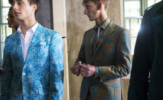 Male models wearing the Richard James collection for Spring / Summer 2016 with stylised colorful hibiscus blooms from deep within the Mexican jungle