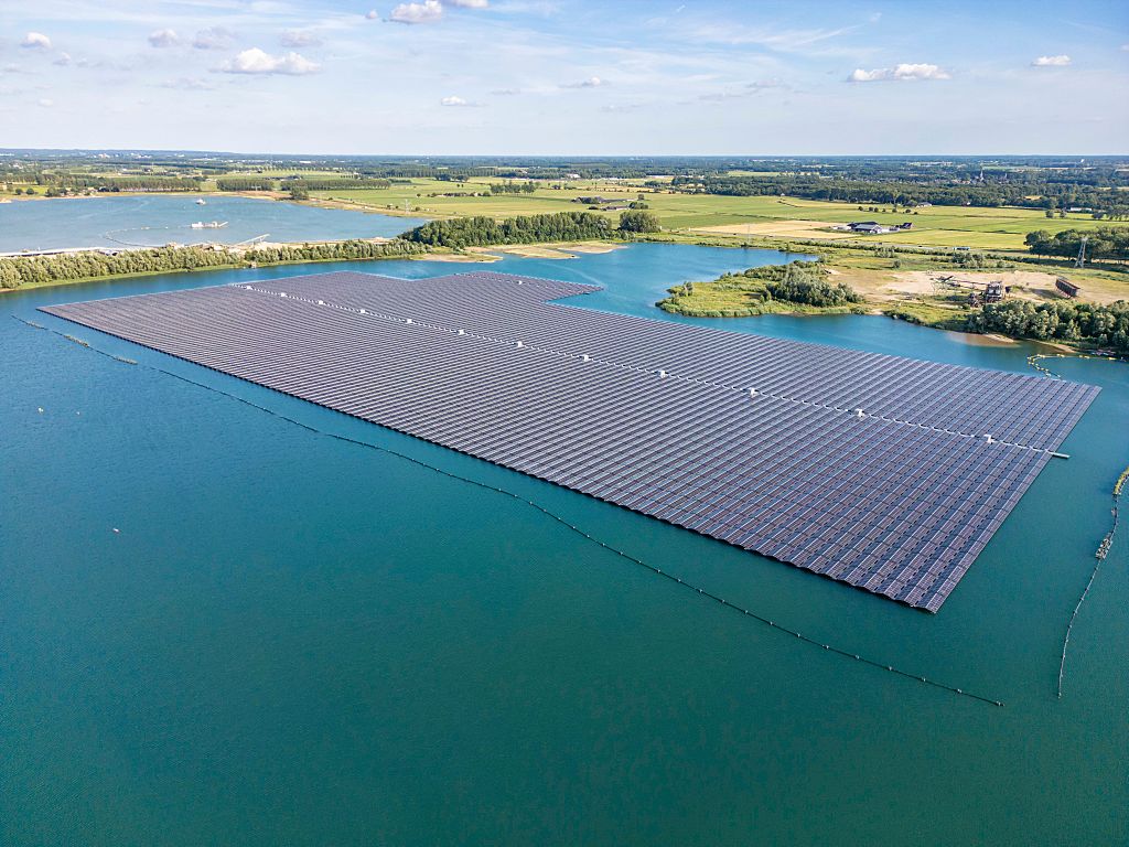 a large-scale floating solar panel installation across a lake near Deest, the Netherlands