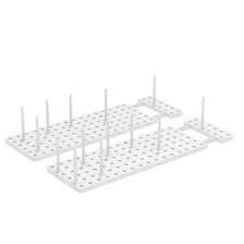 A white plastic pegboard organizer with plastic prongs