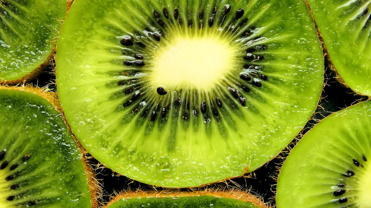 Kiwis cut open showing the colourful inside flesh