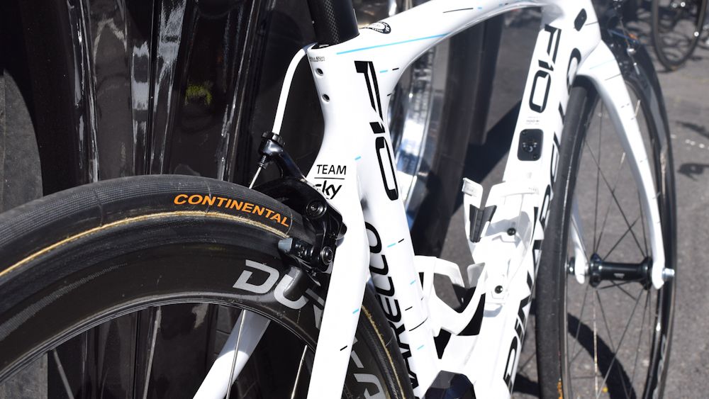 The frame features the same dot-dash design as the black team bikes