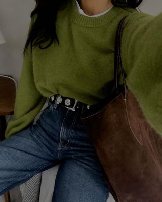 woman in green sweater and jeans