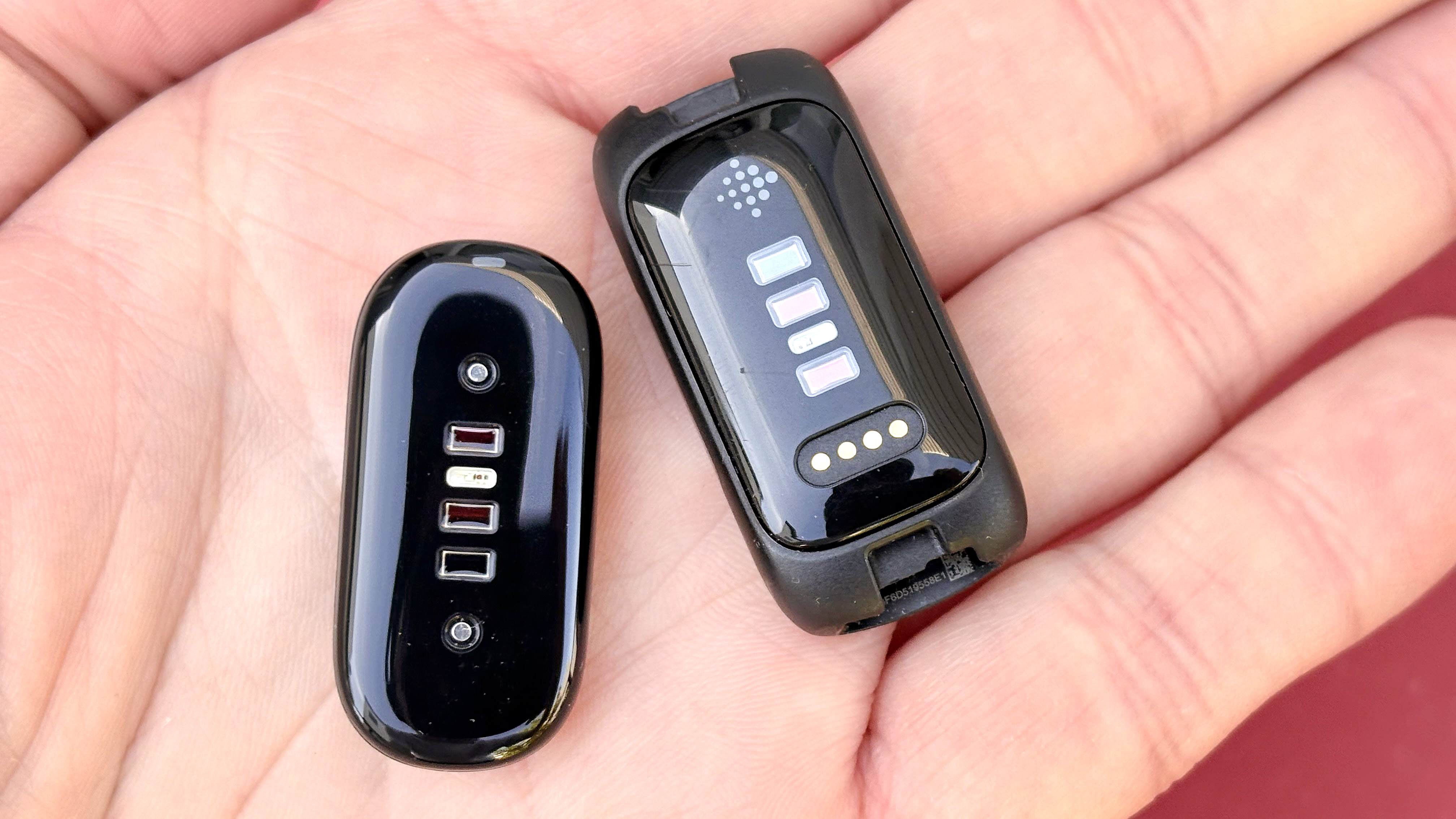 Close-up of the Fitbit Inspire 3 and Fitbit Air in a user's hand