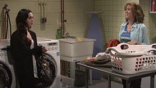 Megan Fox as herself talking to Kristen Wiig as a mother doing laundry on SNL