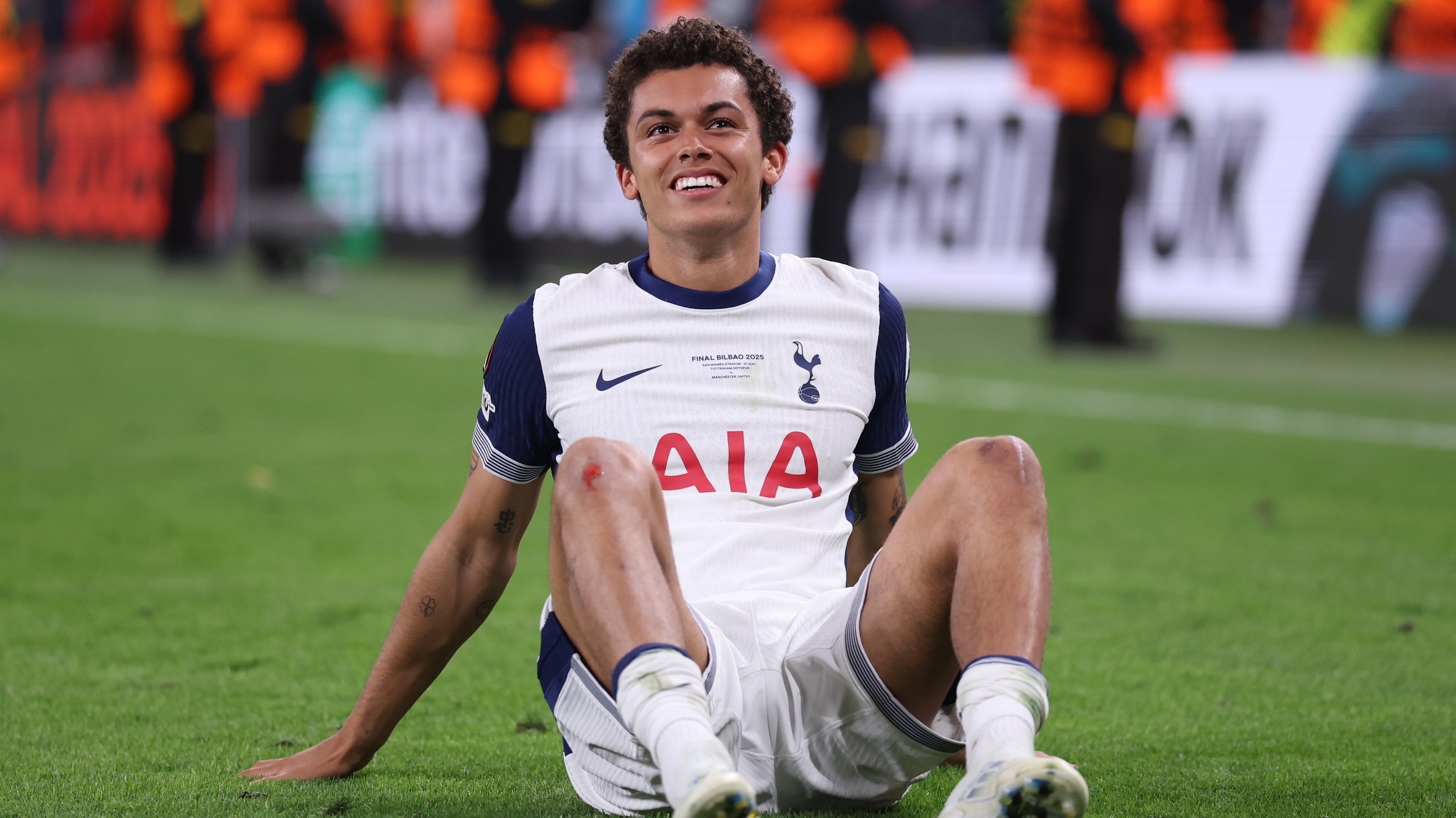 Brennan Johnson celebrates Spurs' Europa League trophy win.
