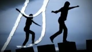 Silhouettes of two teens balancing on blocks in screenshot from The 39 Clues book promo video