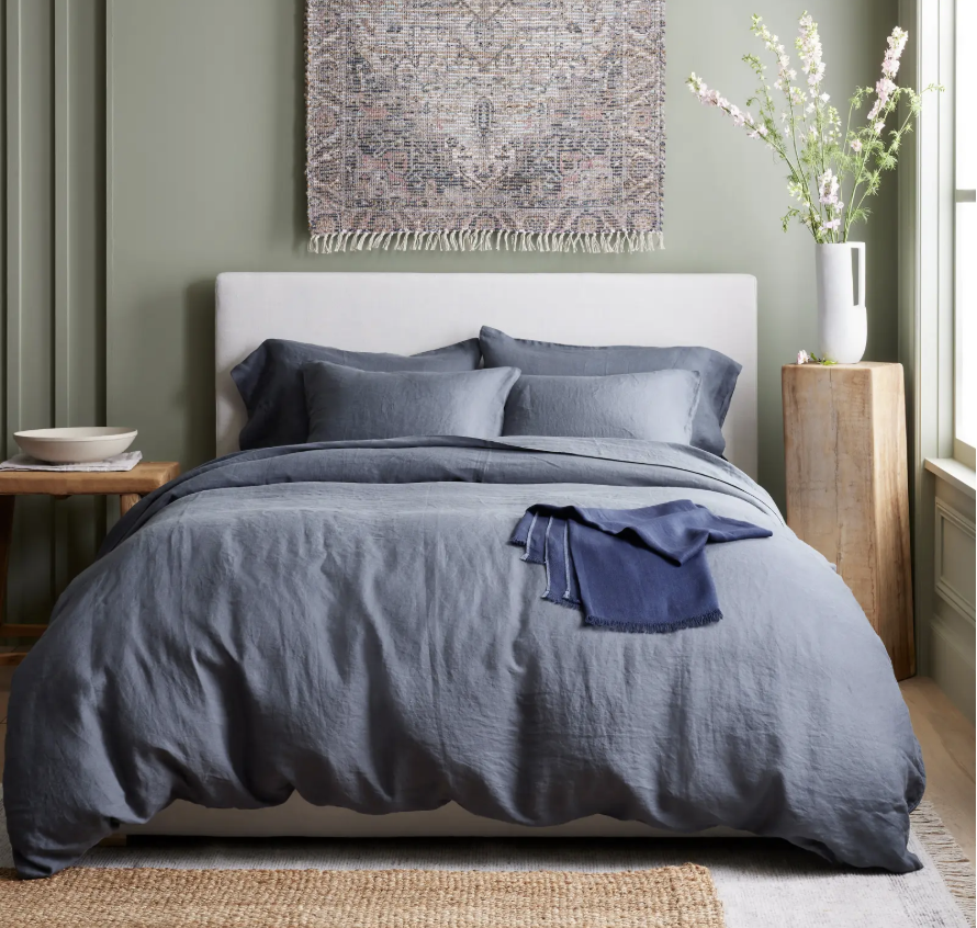 A blue duvet cover from Quince on a bed
