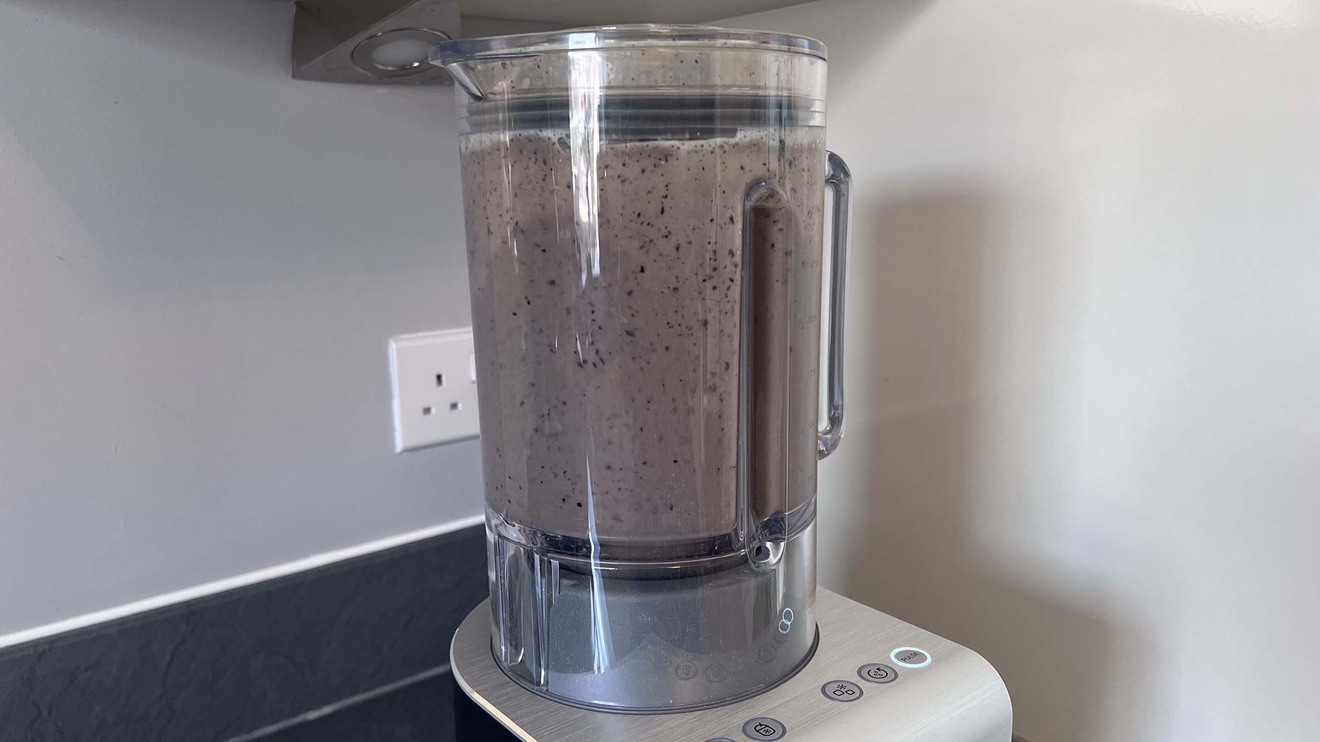 banana, kale and blueberry being blended