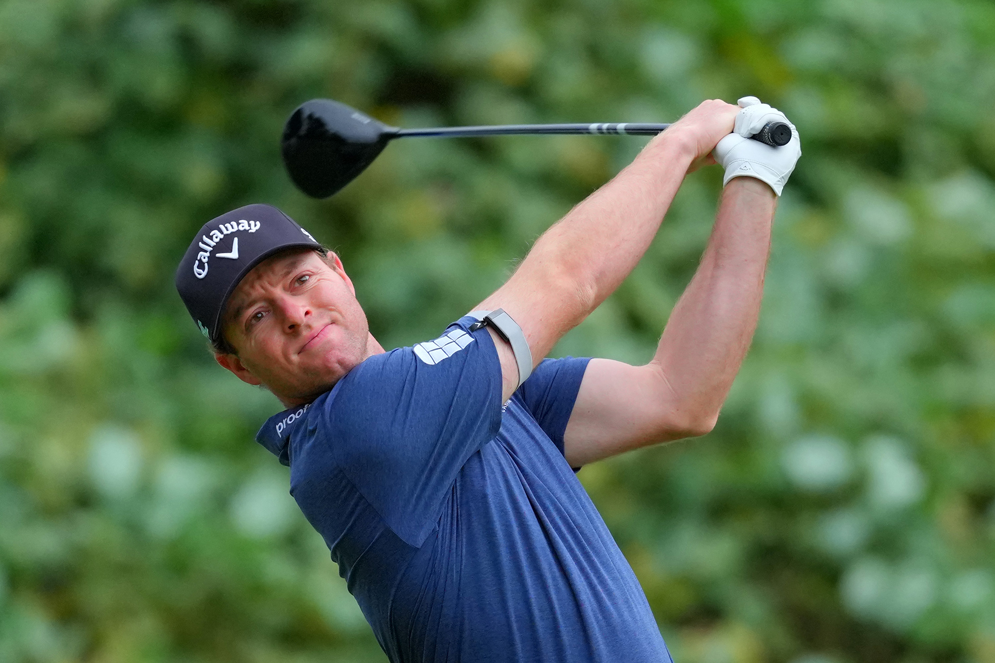 Max Greyserman in the finish position with driver after hitting a tee shot