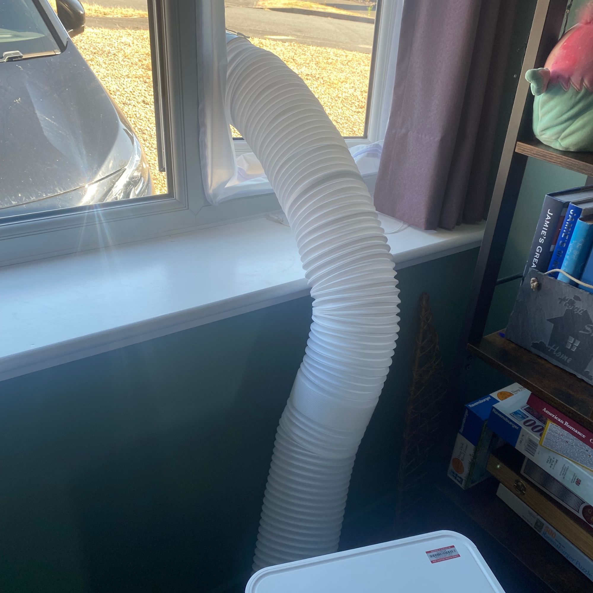The Devola DVAC09CW portable air conditioner vented out of a window in a home office