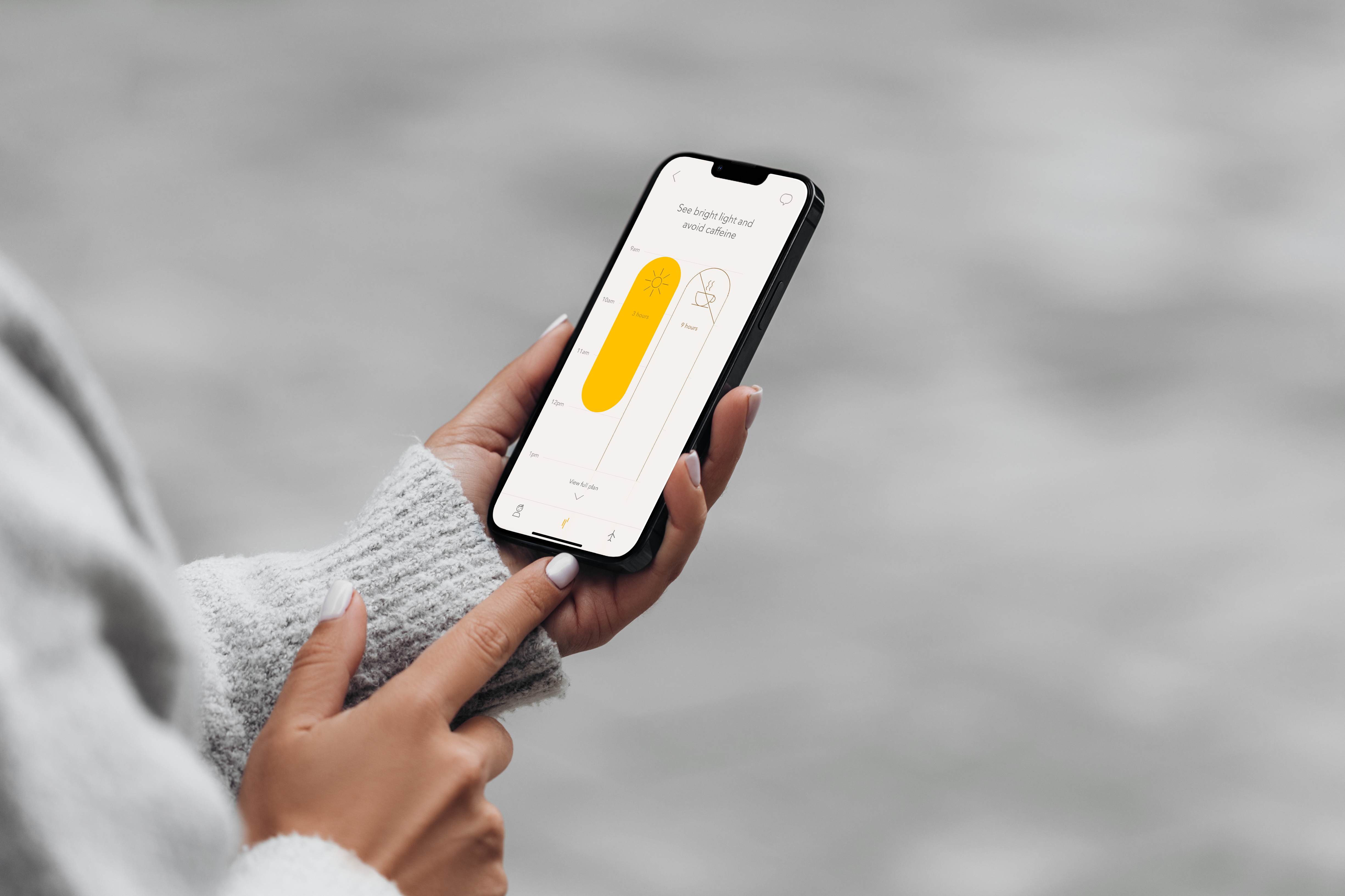A woman looks at a phone with the TimeShifter app on it