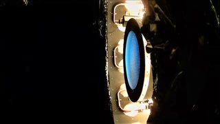The NEXT-C thruster being tested in a vacuum chamber.