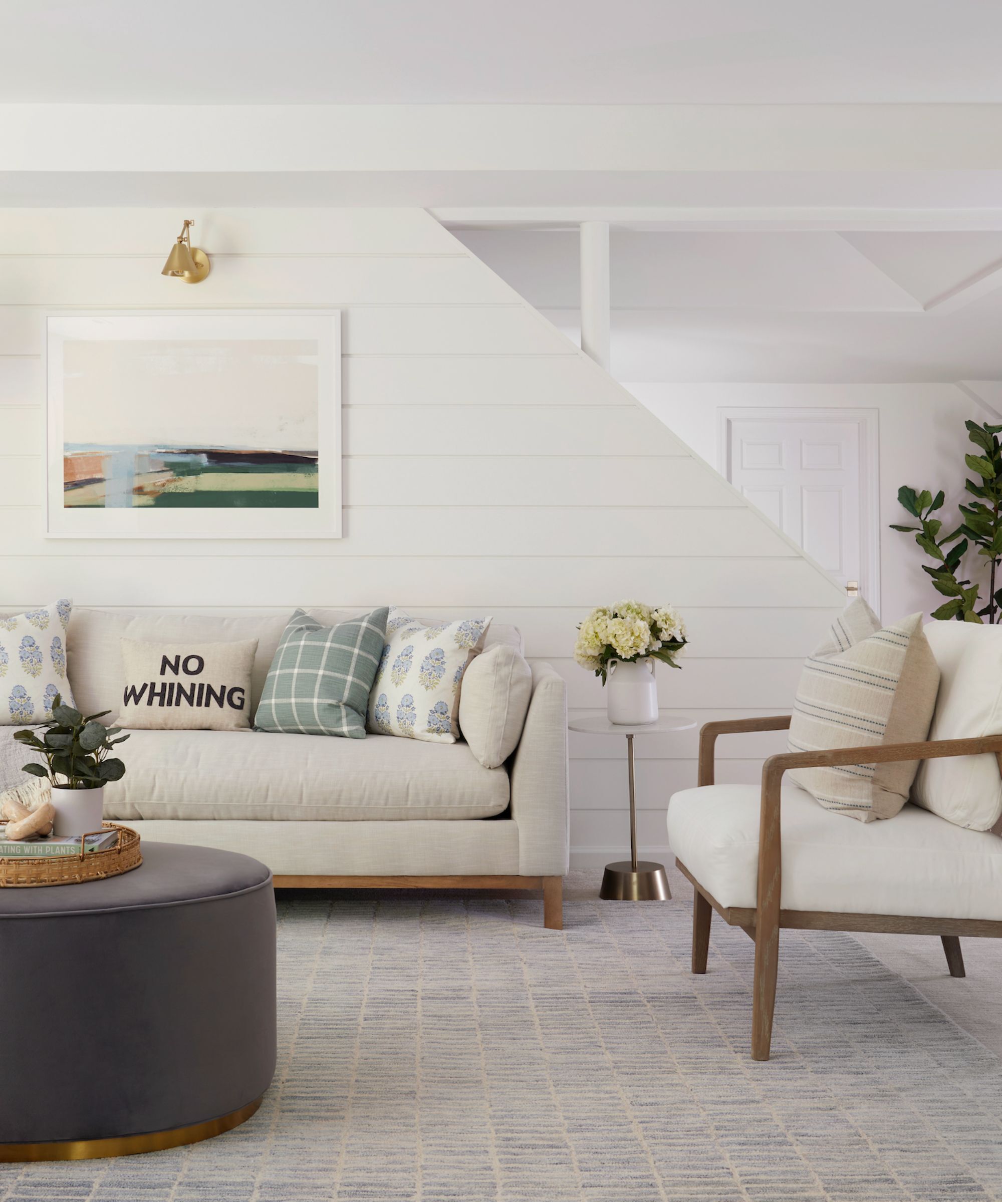 Sitting room with neutral furniture, walls painted in Simply White by Benjamin Moore