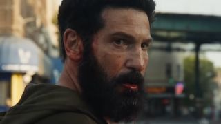 Frank walking through the streets looking paranoid.