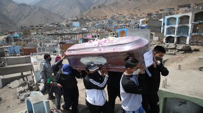 A family buries a victim of Covid on the outskirts of Lima