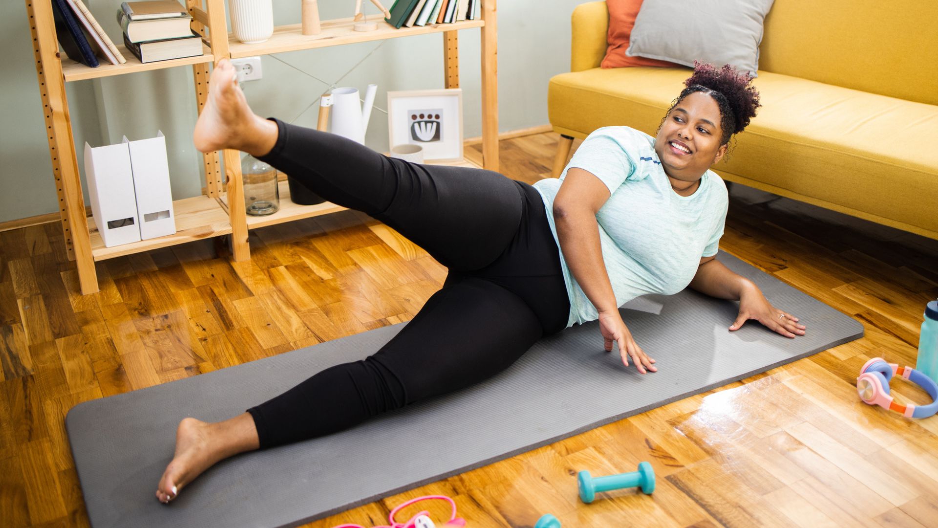 woman on mat does a side leg lift