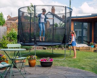 teenagers on trampoline in garden