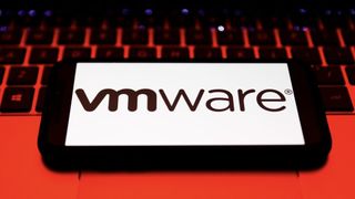 VMware logo on a phone sitting on a laptop keyboard