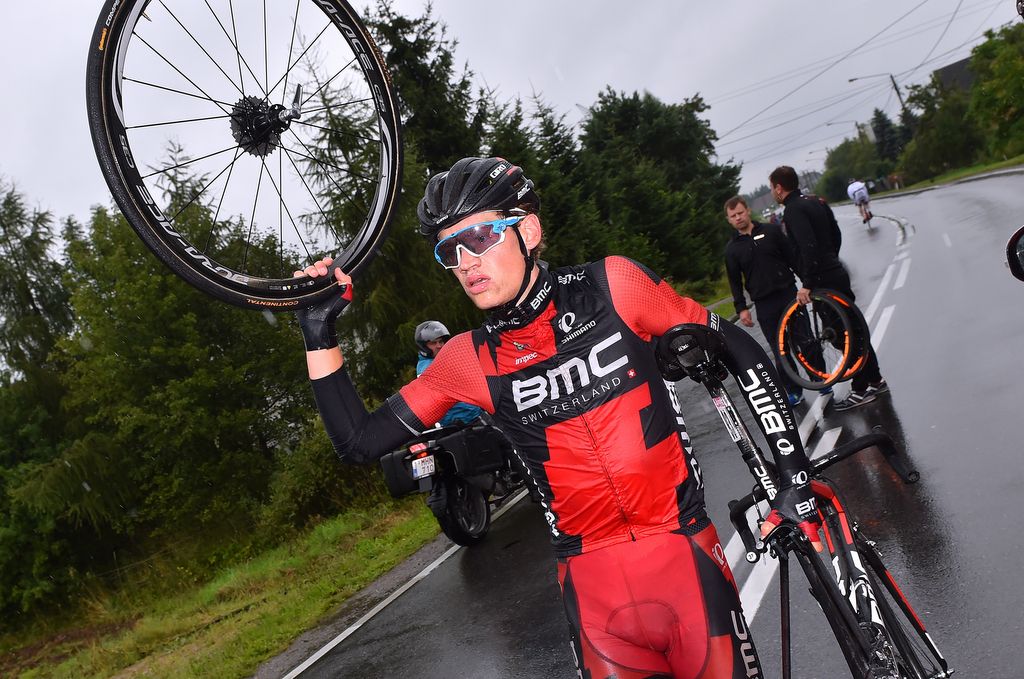 Floris Gerts (BMC) holds up his rear wheel, waiting for the team car