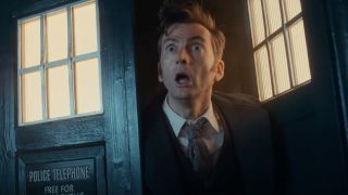 David Tennant as the Fourteenth Doctor standing in the TARDIS' entrance looking shocked