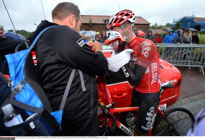Jurgen Van Den Broeck tries to wipe the mud away