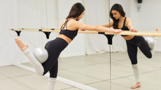 A woman doing a barre workout