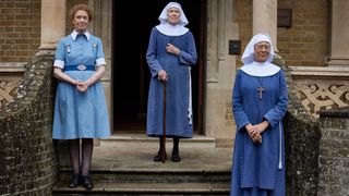 Nurse Crane (LINDA BASSETT), Sister Monica Joan (JUDY PARFITT), Sister Julienne (JENNY AGUTTER) stand outside Nonnatus House in Call the Midwife season 14