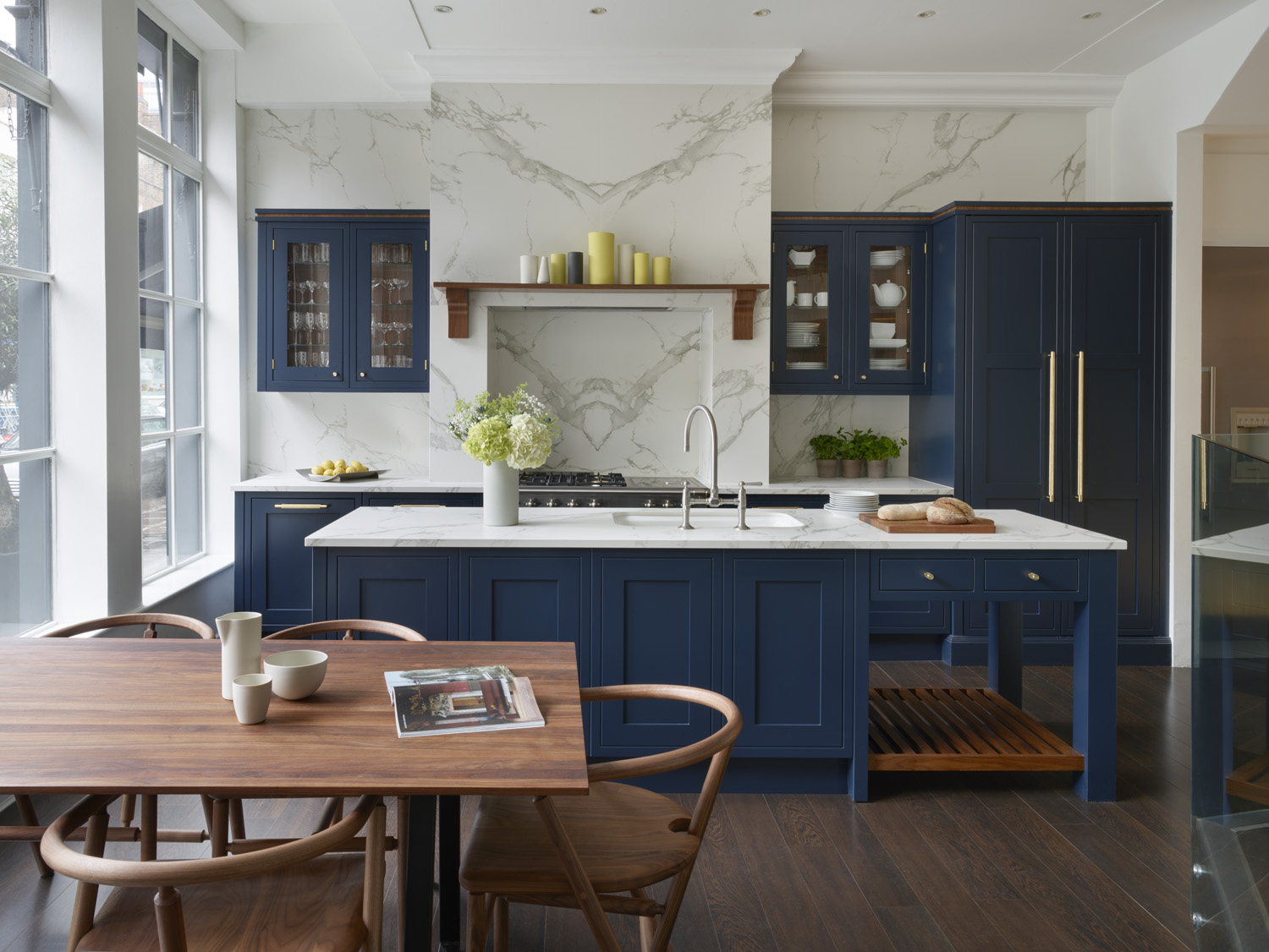 dark blue kitchen with white worktops in open plan space