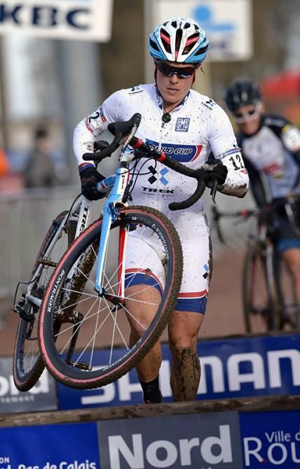World Cup leader Katie Compton (Trek Cyclocross Collective) runs the barrier section.