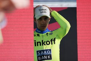 Alberto Contador (Tinkoff-Saxo) adjusts his cap before collecting the maglia rosa