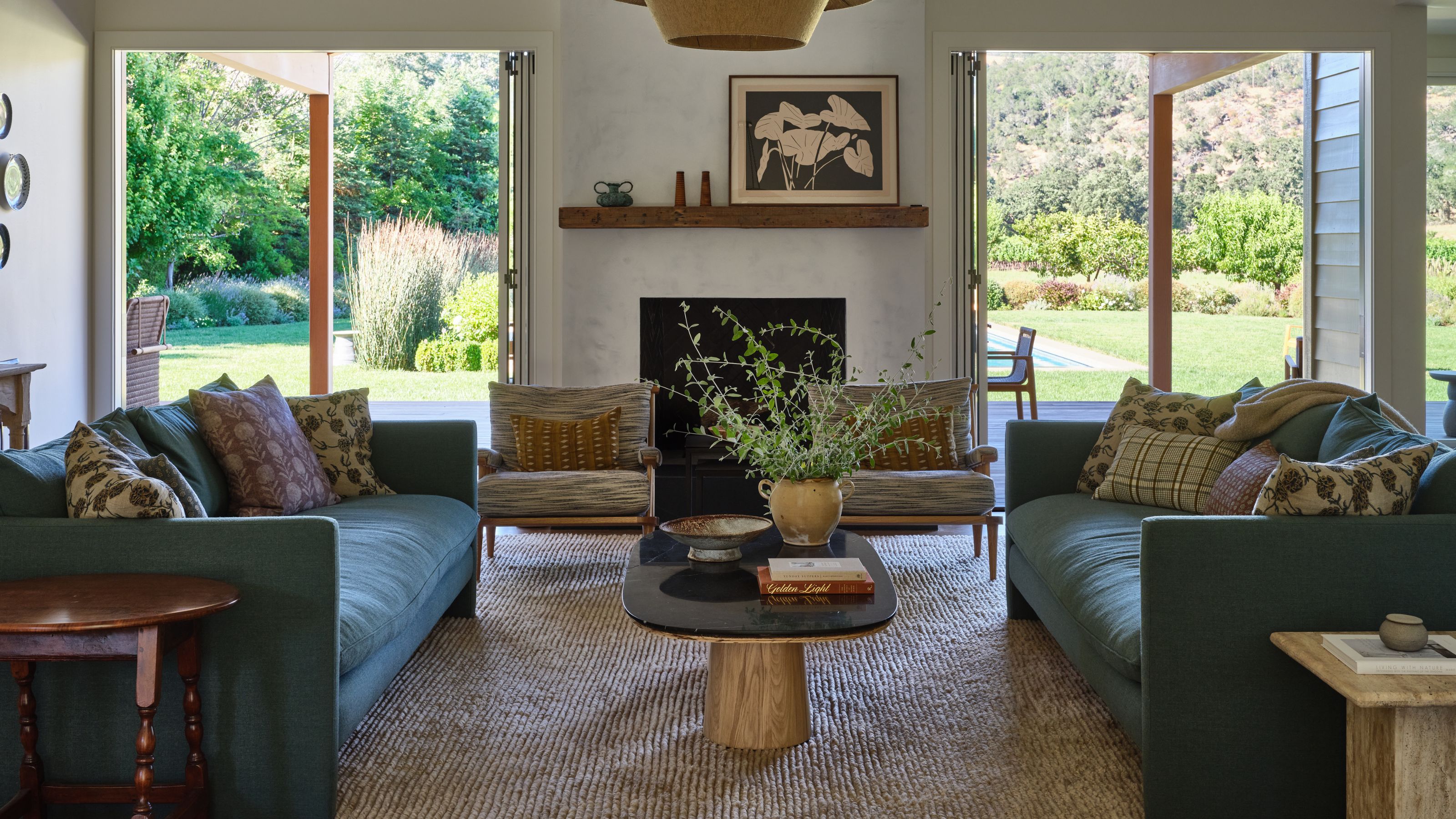 a bright Sonoma open plan living room with patio doors looking out to vineyards and rolling hills