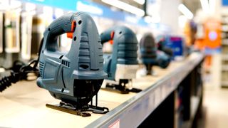 Blue jigsaws lined up in a store with main jigsaw at front in focus