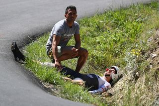 Edward Theuns of Trek-Segafredo lies injured after a crash during the 37km Individual Time Trial stage 13 of the Tour de France