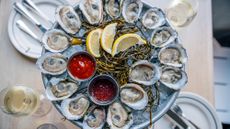 A plate of oysters served with slices of lemon