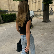 woman wearing cute black top with jeans