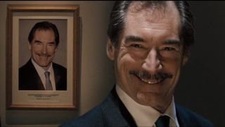 Timothy Dalton smiles in front of his portrait in Hot Fuzz.