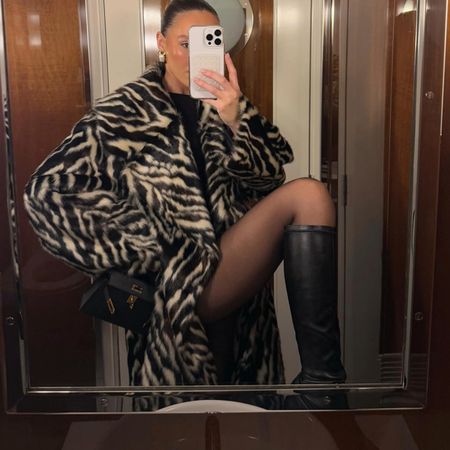 Emma Leger in a zebra coat and black boots