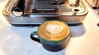 latte art in front of coffee maker