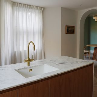 kitchen island unit with sink and gold tap