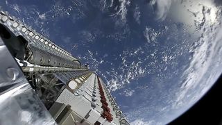 A fleet of SpaceX Starlink internet satellites is seen poised for deployment in orbit in this image from a May 2019 launch.